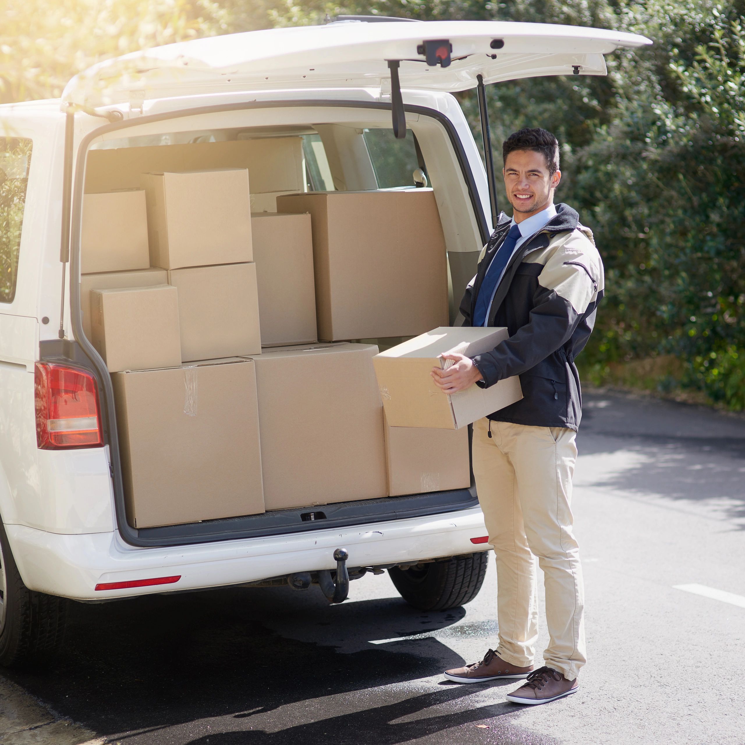 Friendly delivery worker with boxes